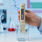 A chemist in a white lab coat testing a glass of water with a digital TDS meter in a laboratory, explaining the science behind a high TDS reading.